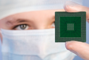 Technician holding a computer chip